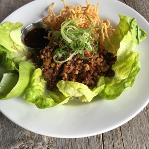 Chinese lettuce cups with stir-fried chicken, shitake mushrooms, sesame oil, crispy ramen noodles; a great shared plate or a hearty salad option.
